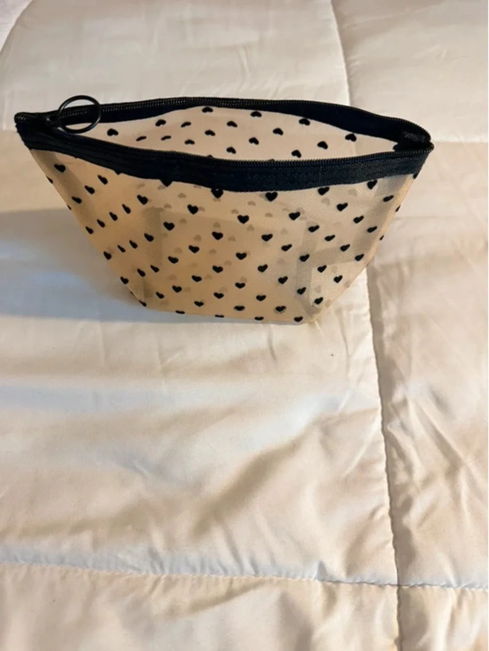 Black heart mesh pouch with black heart pattern on beige